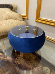 Blue round Turkish hotpoy with gold accents in a decorative room